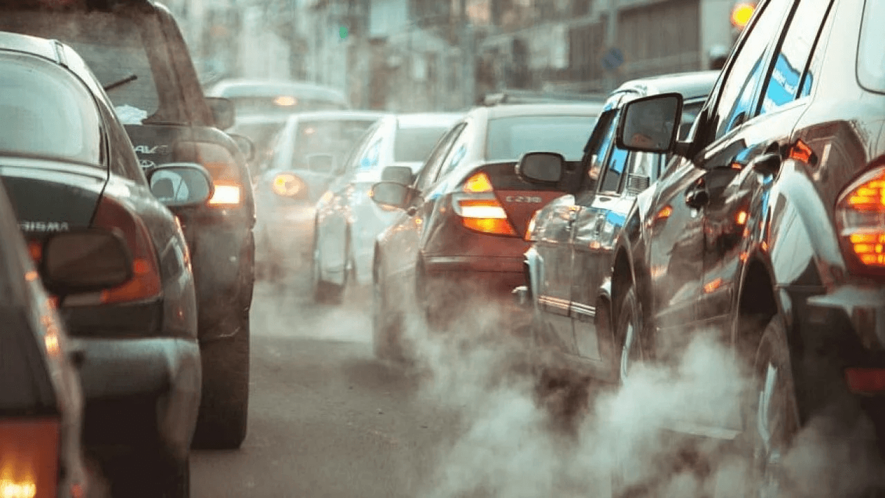 Vehicle exhaust fumes billowing from cars stuck in traffic congestion