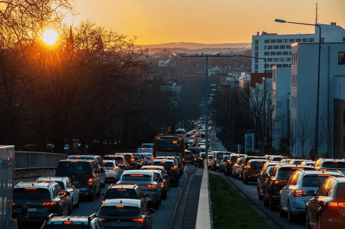 Heavy rush-hour traffic congestion on a city road at sunset