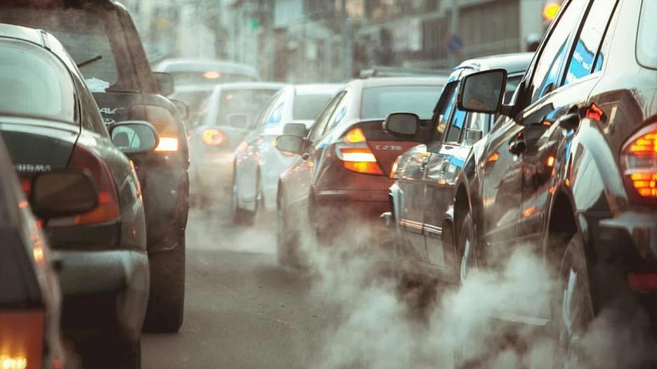 Vehicle exhaust fumes billowing from cars stuck in traffic congestion